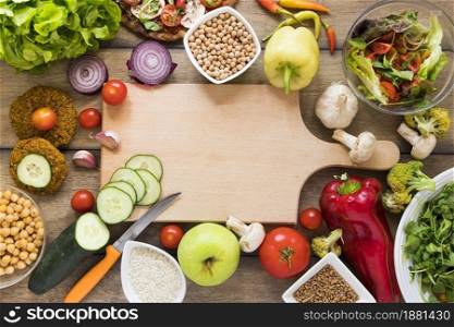 cutting board surrounded by vegetables
