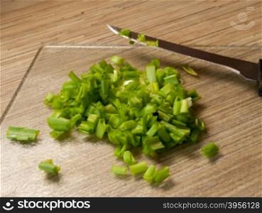 cutting Board with onions. chopped green onions on a kitchen cutting Board