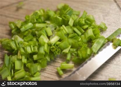cutting Board with onions. chopped green onions on a kitchen cutting Board