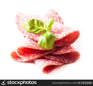 Cutting cold salami slices close up isolated on white. Salami slices isolated