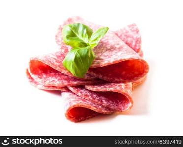 Cutting cold salami slices close up isolated on white. Salami slices isolated