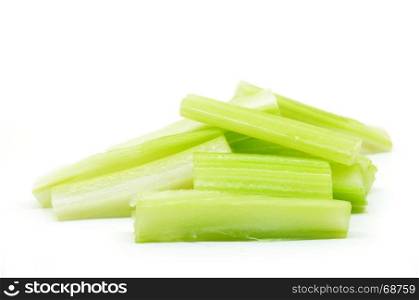 Cutting fresh bunch of celery isolated over white background