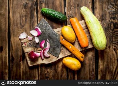 Cutting fresh vegetables for soup. On a wooden table.. Cutting fresh vegetables for soup.