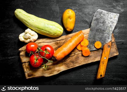 Cutting ingredient for soup. On a black wooden background.. Cutting ingredient for soup.