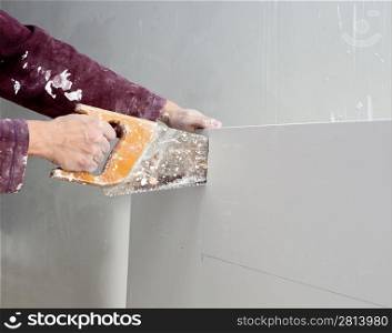 cutting plasterboard plaster hand with grunge dirty saw