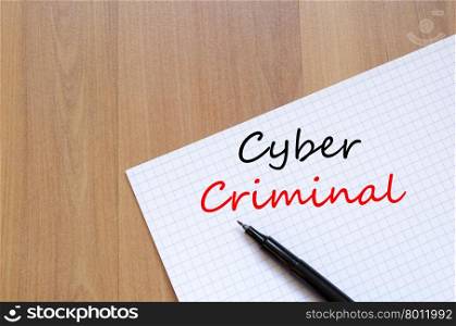 Cyber criminal text concept write on notebook with pen
