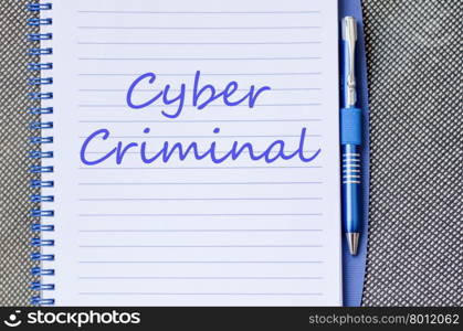 Cyber criminal text concept write on notebook with pen