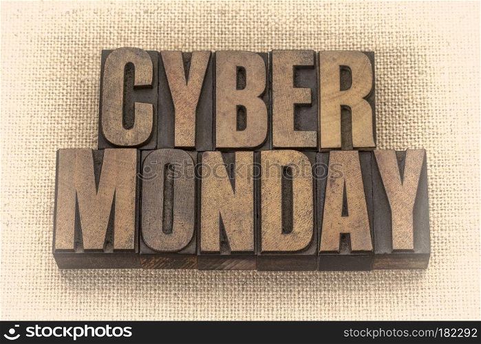 Cyber Monday - internet holiday shopping - text in vintage letterpress wood type against burlap canvas, sepia toned image