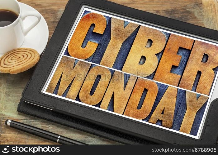 Cyber Monday - online shopping and marketing concept - word abstract in letterpress wood type printing blocks on a digital tablet with a cup of coffee