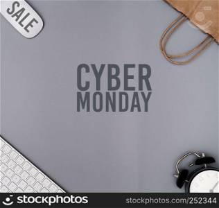 Cyber Monday Sale on gray background, workspace with shopping bag
