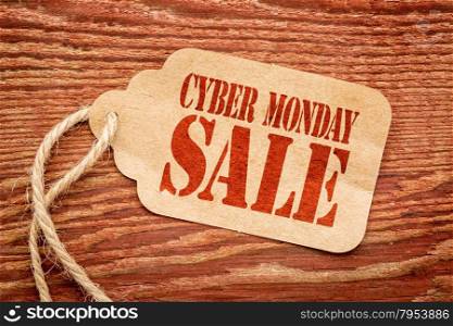 Cyber Monday sale sign a paper price tag against rustic red painted barn wood
