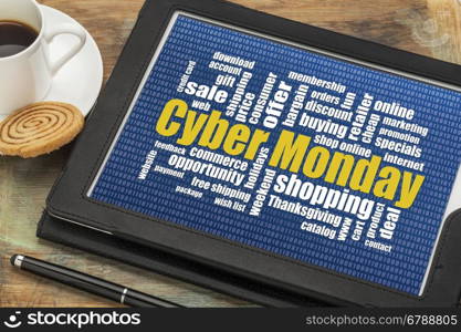 Cyber Monday word cloud on a digital tablet with a cup of coffee - a holiday online shopping concept