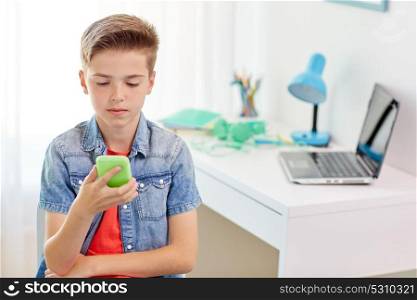 cyberbullying, people and communication concept - boy with smartphone being bullied by text message at home. boy with smartphone being bullied by text message
