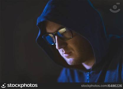 cybercrime, hacking and people concept - close up of hacker in glasses and hoodie. close up of hacker in glasses and hoodie. close up of hacker in glasses and hoodie
