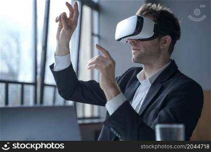 Cyberspace in business. Excited man office worker wearing vr goggles touching objects with hands in digital world, amazed businessman in 3d glasses interacting with virtual reality at work. Excited man office worker wearing vr goggles touching objects with hands in digital world