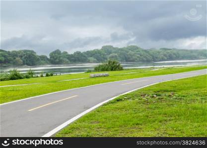 Cycling and jogging path by riverside recreational area