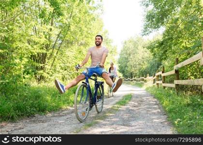 cycling, leisure and lifestyle concept - happy young couple with bicycles at summer park. happy couple with bicycles at summer park