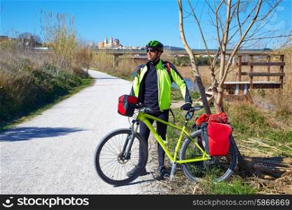 cycling tourist MTB cyclist in Ribarroja Parc de Turia with paniers and saddlebag