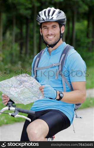 cyclist man checking map and looking around