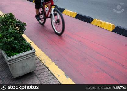 cyclist on a red bike path in modern city