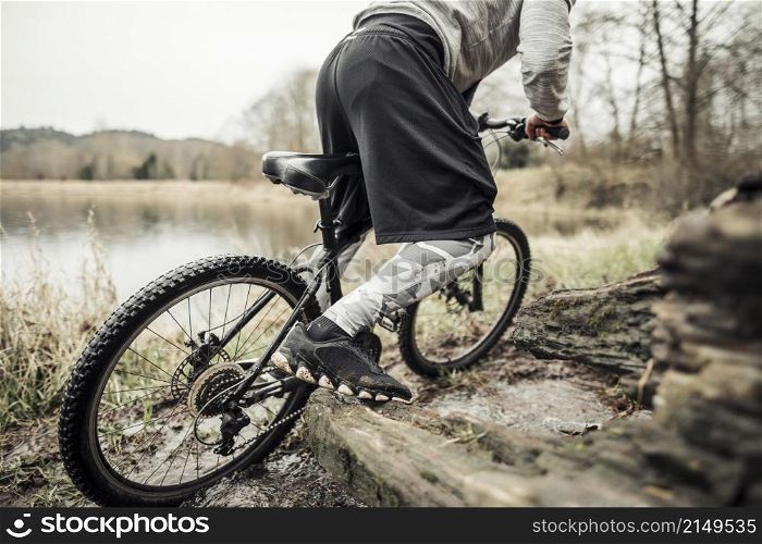cyclist riding bike near lake
