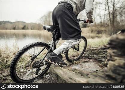 cyclist riding bike near lake