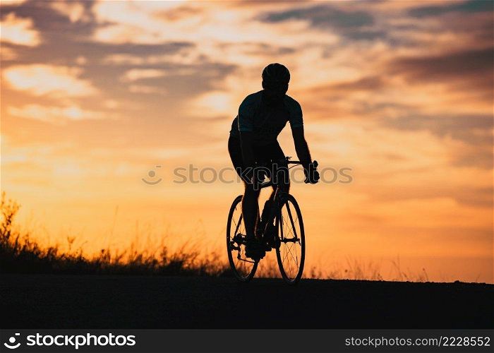 cyclist silhouette at sunset sports and fitness concept