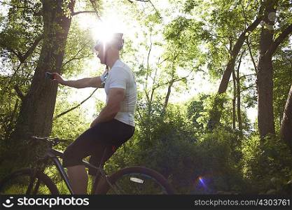 Cyclist stopping for break in forest