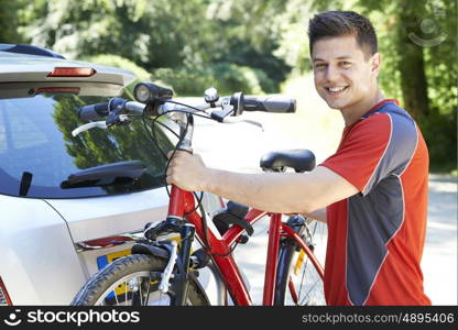 Cyclist Taking Mountain Bike From Rack On Car