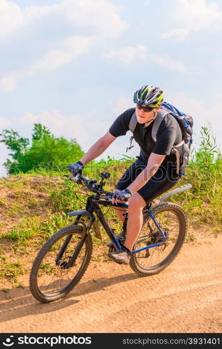 cyclist wearing a helmet on a mountain bike moves