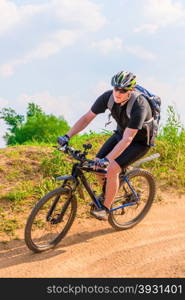 cyclist wearing a helmet on a mountain bike moves