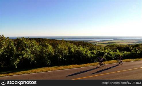 Cyclists riding in Gatineau Park, Quebec Canada.