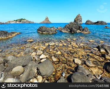 Cyclopean Coast and the Islands of the Cyclops on Aci Trezza town (Italy, Sicily,10 km north of Catania). Known as Isoles Dei Ciclopi Faraglioni.