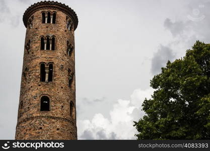 Cylindrical bell tower (VIII-IX centuries) of countryside church of Campanile, located in the village of Santa Maria in Fabriago in Emilia Romagna region in northern Italy: windows with one, two and three lights in traditional romanesque style from bottom to top