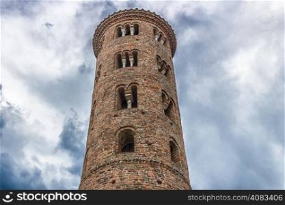Cylindrical bell tower (VIII-IX centuries) of countryside church of Campanile, located in the village of Santa Maria in Fabriago in Emilia Romagna region in northern Italy: windows with one, two and three lights in traditional romanesque style from bottom to top
