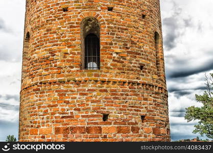 Cylindrical bell tower (VIII-IX centuries) of countryside church of Campanile, located in the village of Santa Maria in Fabriago in Emilia Romagna region in northern Italy: windows with one, two and three lights in traditional romanesque style from bottom to top