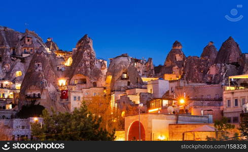 Cylindrical stone cliffs and cave houses in Goreme, Turkey. Night Goreme city, Turkey