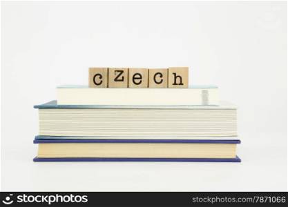 czech word on wood stamps stack on books, language and study concept