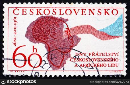 CZECHOSLOVAKIA - CIRCA 1961: a stamp printed in the Czechoslovakia shows Woman, Map of Africa and Flag of Czechoslovakia, circa 1961