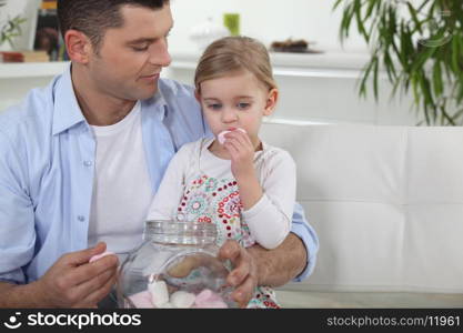 Dad and his daughter eating marshmallows