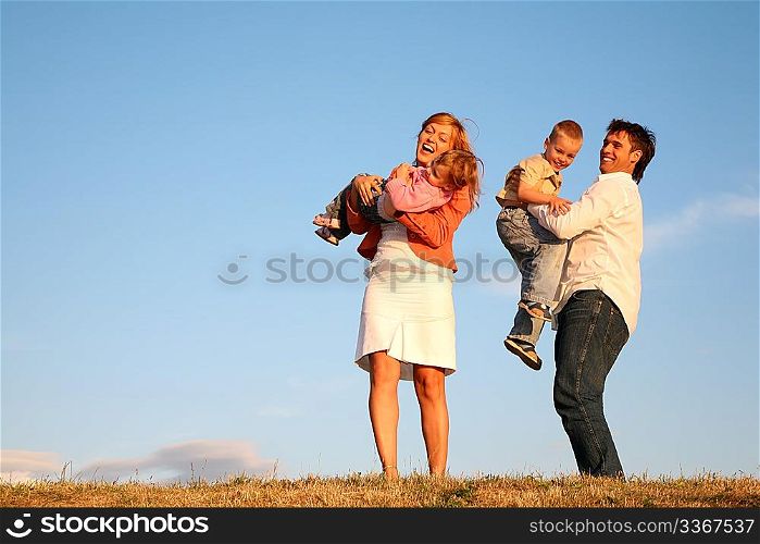 dad and mom hold children on the hands