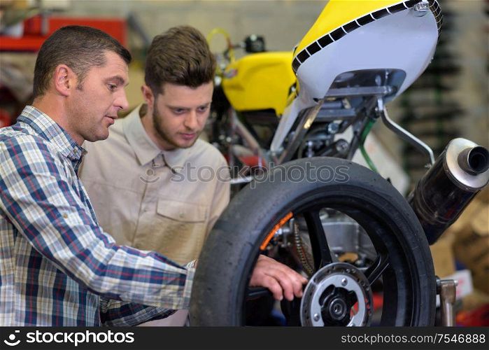 dad and son checking a motorbike