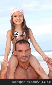 Dad carries daughter on his shoulders