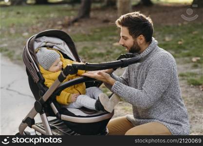 dad child stroller outdoors nature