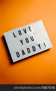 Dad day sign over a pastel pink background says love you daddy, love concept, minimal, copy space, style design