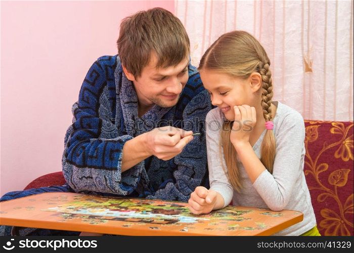 Dad holds daughter fun puzzle element
