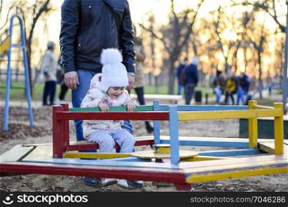 Dad plays with his daughter on the playground. Dad plays with his daughter on the playground.