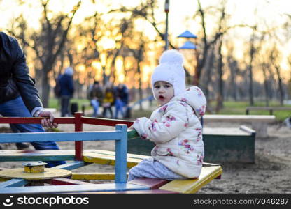 Dad plays with his daughter on the playground. Dad plays with his daughter on the playground.