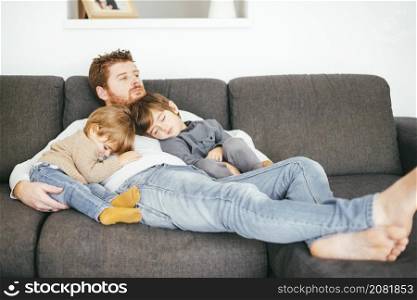 dad taking nap with sons sofa