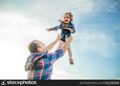 dad throws up the girl in the sky